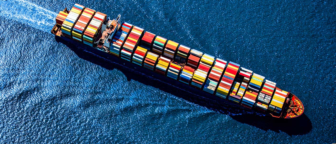 A ship sailing in the sea with Shipping Containers